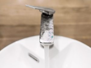 Image of tap, with hard water and limescale buildup